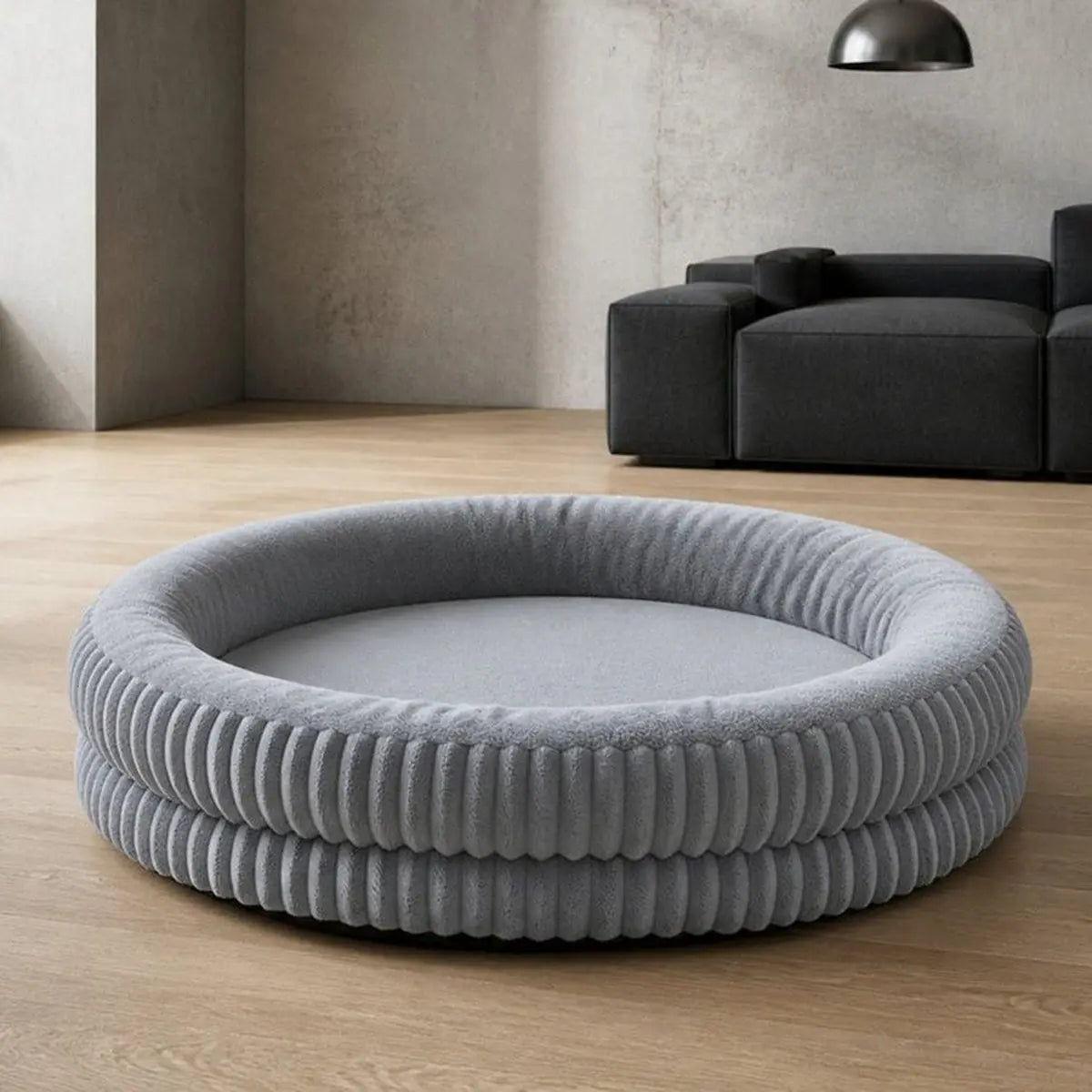 Grey deep sleep round dog bed in a bright room